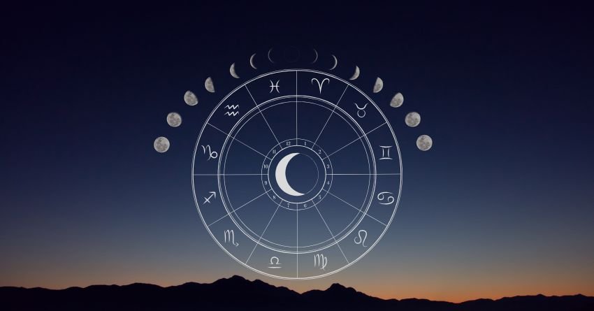 Glowing zodiac wheel against a dark blue twilight sky with warm golden light along the horizon