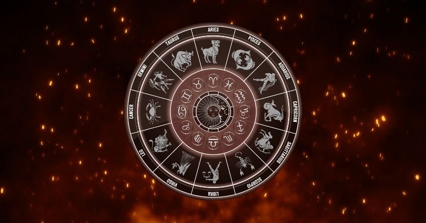 Silver zodiac wheel surrounded by glowing orange sparks against a dark red cosmic background
