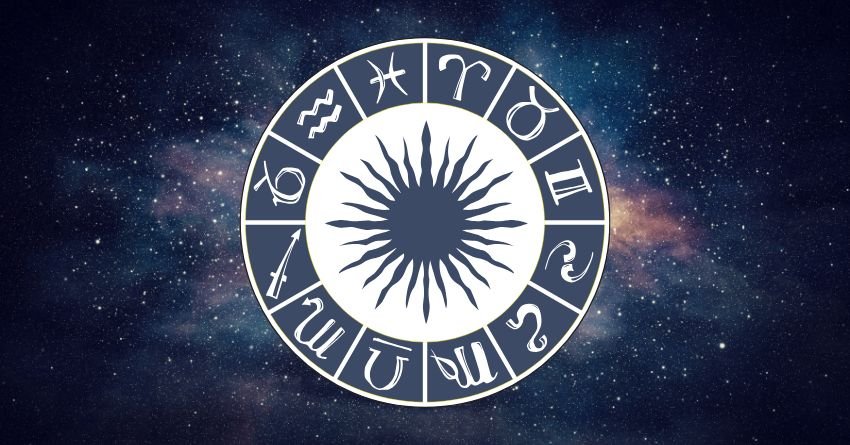 Glowing silver zodiac wheel with a radiant central star against a dark blue cosmic background