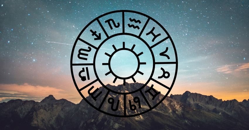 Glowing zodiac wheel against a cloudy sky with warm sunset colors