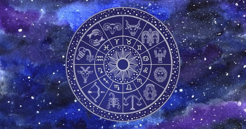Purple zodiac wheel surrounded by glowing violet and blue cosmic clouds
