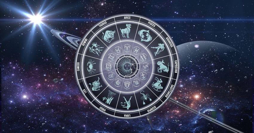 Silver zodiac wheel glowing against a dark cosmic background with bright stars and celestial light