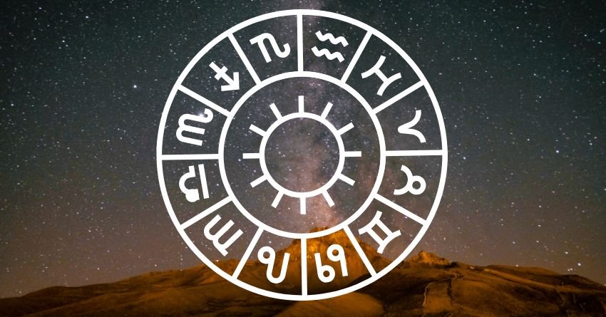 White zodiac wheel glowing against a dark sky with warm orange light near the horizon