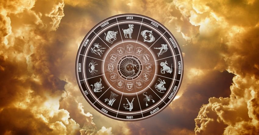 Golden zodiac wheel surrounded by dramatic glowing clouds and warm celestial light