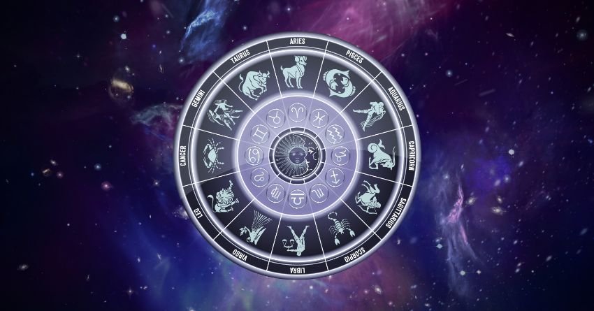 Glowing silver zodiac wheel on a purple cosmic background with stars and galaxy-like light