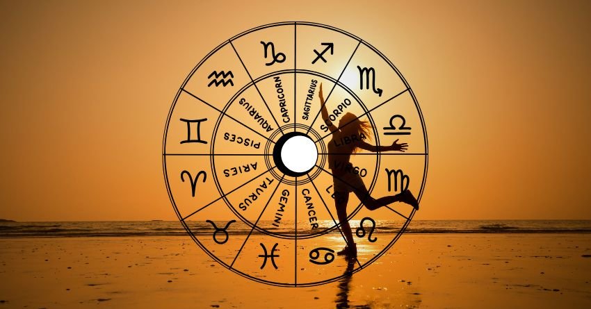 Golden zodiac wheel over a sunset landscape with a silhouetted cyclist in the foreground