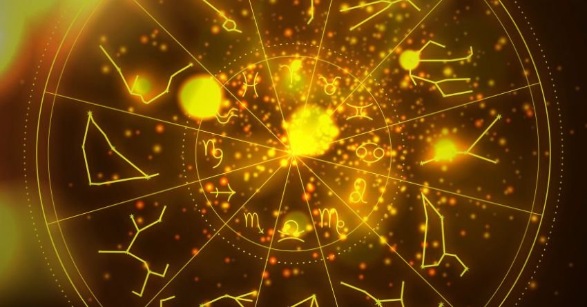 Glowing golden zodiac wheel surrounded by bright celestial lights, sparkling stars, and fiery yellow cosmic energy