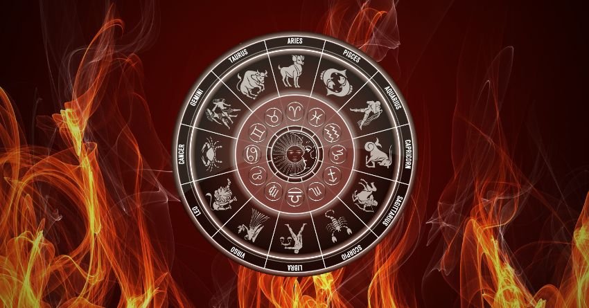 Glowing silver zodiac wheel surrounded by fiery orange flames and dark red cosmic clouds