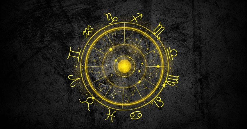 Glowing golden zodiac wheel with bright yellow celestial symbols against a dark cosmic background